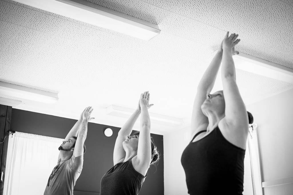 Black and white picture of people doing yoga