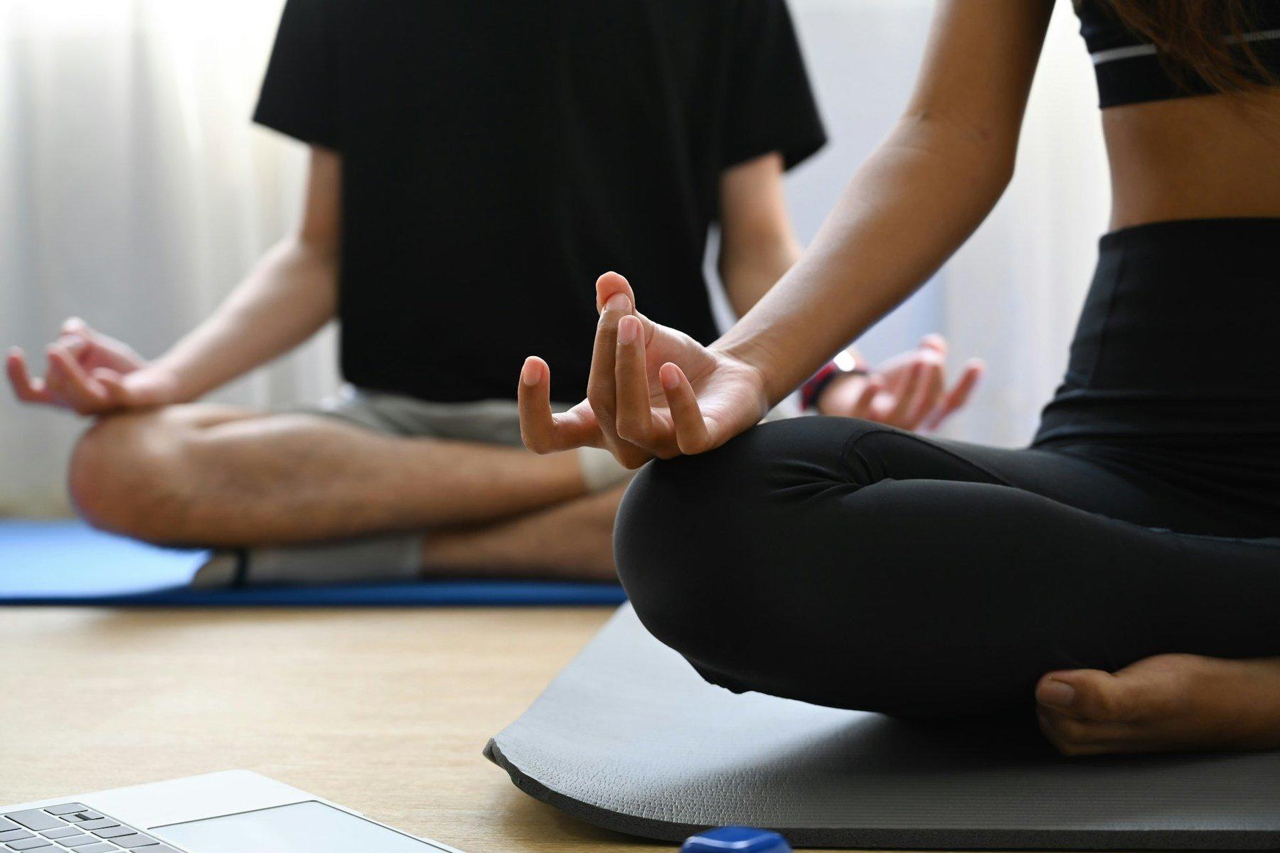 Two students in cross legged pose